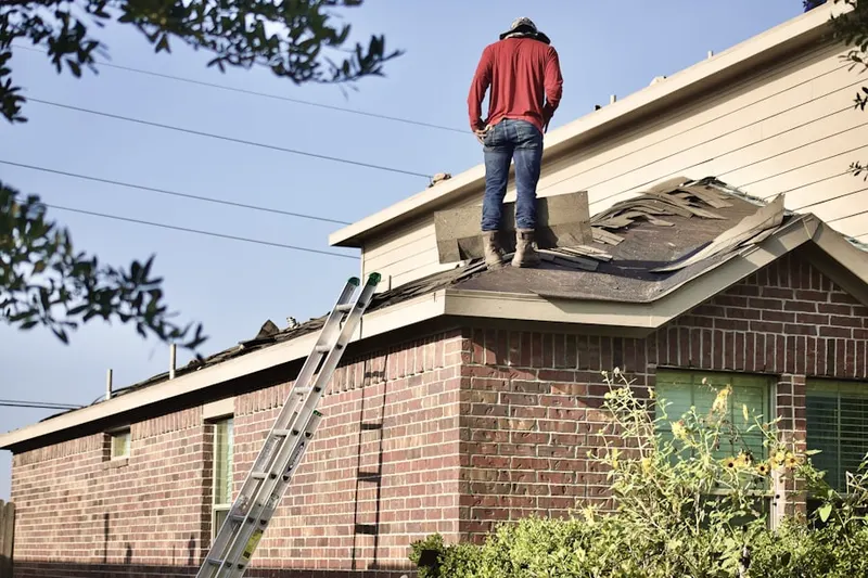 Professional roofer working on a residential roof in Huntington Park